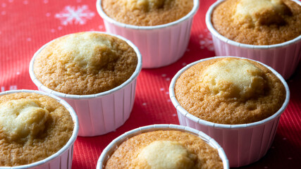 Cupcakes without decoration in red molds. The view from the top. Selective focus.