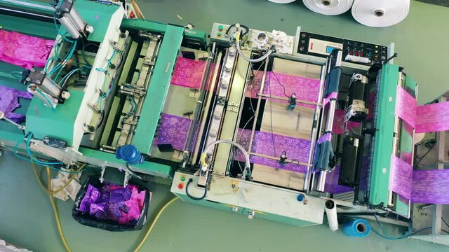 Top view of a colourful plastic bag manufacturing machine at a polyethylene production factory