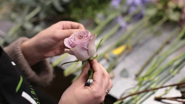 girl florist prepares flowers for making a bouquet of flowers