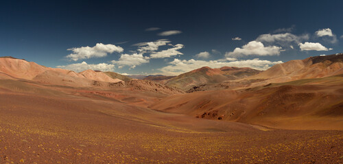 Volcanic landscape. Panorama view of the arid desert, brown and red Andes mountains, dry valley and colorful hills in Laguna Brava, La Rioja, Argentina.