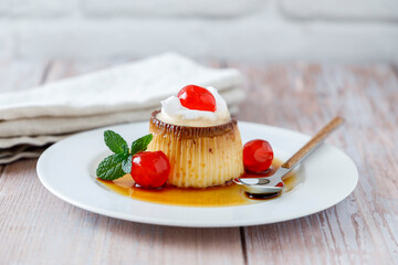 Egg flan with cream, cherries and mint