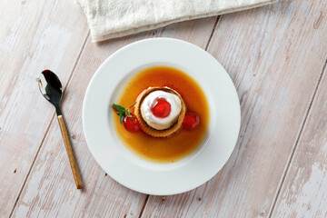 Egg flan with cream, cherries and mint