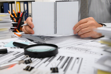 business concept - businessman working with reports in office, table and workspace close view,...