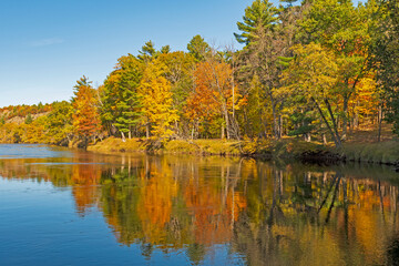 Fototapeta na wymiar Fall Reflections on a Calm River