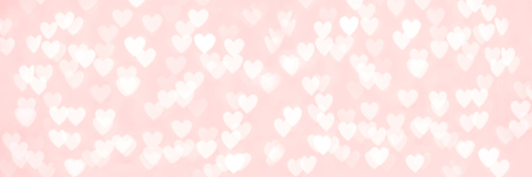 Abstract red pink heart glitter light bokeh holiday and festive party background. Love sentiment and St Valentine's day concept backdrop long banner with copy space