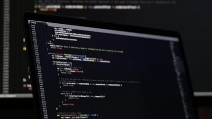 Real Javascript code. Front end web development. Java script JS code on laptop screen. Web design concept.