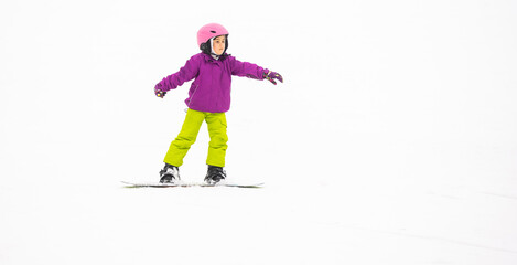 Obraz na płótnie Canvas Snowboard Winter Sport. little girl learning to snowboard, wearing warm winter clothes. Winter background.