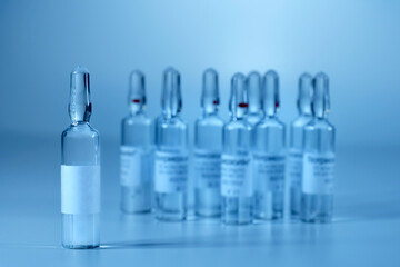 Ampoules with medicine, on a gray background. Vaccination and Immunization. Toned in blue image. Health care concept