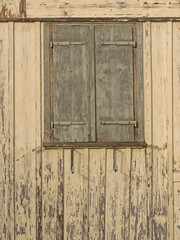 Obraz na płótnie Canvas Window with closed, weathered shutters
