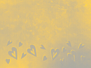 yellow wooden heart shapes on grey concrete surface. Demonstrating trendy colors of year 2021
