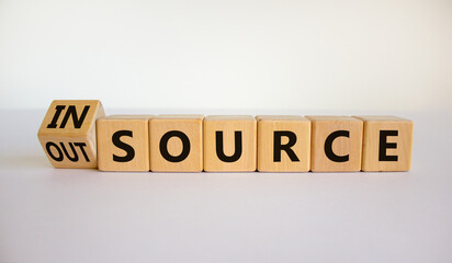Outsource or insource symbol. Fliped wooden cubes and changed the word 'outsource' to 'insource'....