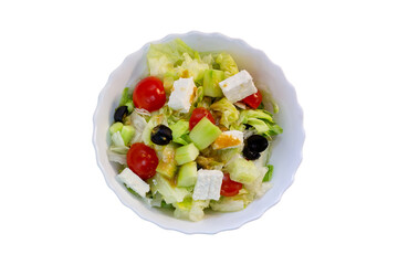 Fresh greek salad in a white plate isolated on a white background.