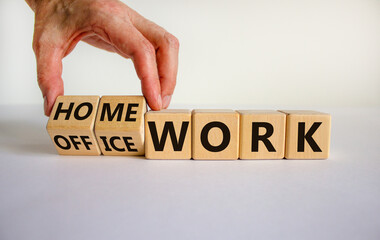 Back to normal. Hand turns cubes and changes words 'home work' to 'office work' or vice versa. Beautiful white background. Copy space, business and home or office work concept.