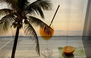 multiple photographic exposure with beautiful beach with coconut tree and orange juice