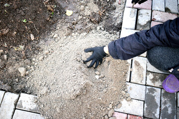 work near the house, leveling the area for paving slabs, close-up