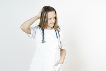 Medicine and health concept. Doctor woman holds her head with her hand. Isolated on white background.