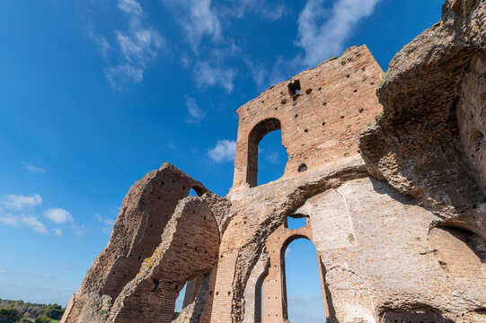 Beautiful architectural perspective of the Imperial Villa of the Quintilii, the caldarium, of the thermal baths, on a beautiful day of blue sky the ruins stand out against the blue. Rome Appia Antica