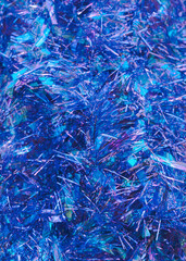 Blue shiny tinsel texture Close up photo Blue sparkle decorative frippery Christmas backdrop