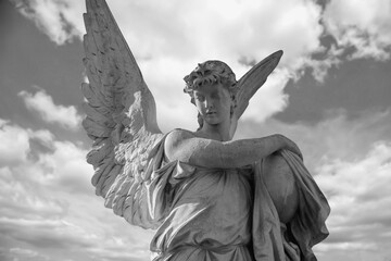 Black and white image of sad angel with urn with dust as symbol of death, pain, fear and end of...