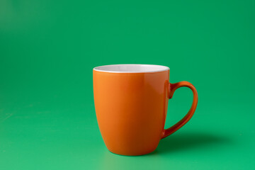 Big red mug on green background, horizontal.