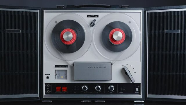 Reel to reel tape recorder playing rewind. Rotating vintage music player close up. Retro tape. Spinning reels metallic color. Party. Loop. Front view. Front view. Popular Disco Trends 60s, 70s, 80s