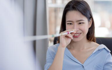 Portrait of asian woman doing eye test in optical lab