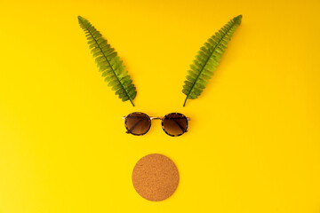 Reindeer silhouette with sunglasses on the yellow background. Top view isolated.