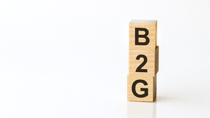 B2G - acronym from wooden blocks with letters, Business-to-government. White background.