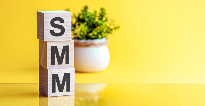 SMM - acronym from wooden blocks with letters, concept. SMM - Social Media Marketing