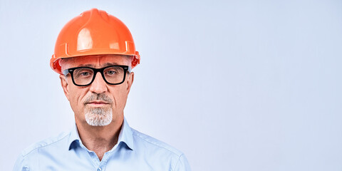 Adult man in glasses and hardhat in studio