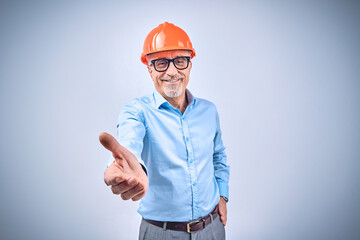 Happy adult man standing with outstretched hand for greeting