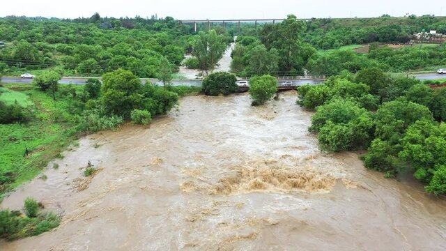 Aerial fly over view of a river coming down in flood due to heavy rains from climate change