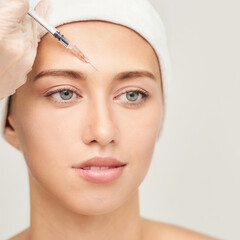 Forehead injection at spa salon. Doctor hands. Closeup. High quality. Pretty female patient. Beauty...