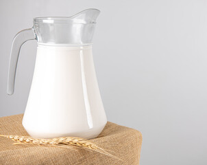 A jug of  fresh milk glass on sackcloth for a background..Raw milk is high in calcium and protein to drink for all ages..Milk consumption nutritious and healthy dairy products concept..