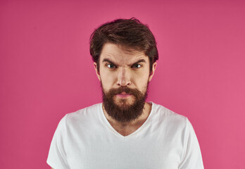 Fototapeta premium Portrait of a man t-shirt on a pink background cropped view