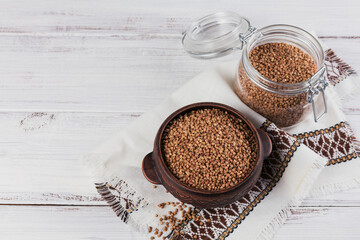Buckwheat groats closeup. Grains of raw buckwheat as a background texture.