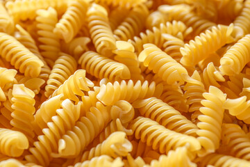 Dry pasta fusilli. Fusilli have spiral shape and yellow color. Pasta is delicious Italian traditional food made from wheat flour like noodles.Pasta background.Top view
