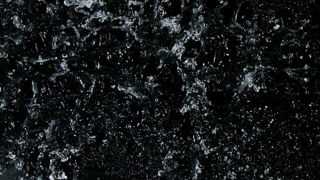 Water splashing on black background, super slow motion. Filmed on high speed cinema camera, 1000 fps.