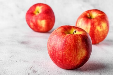  red apples on blackboard or chalkboard background. Bright fruit composition. Close-up on a gray background.