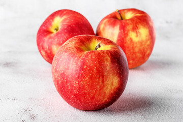 red apples on blackboard or chalkboard background. Bright fruit composition. Close-up on a gray background.