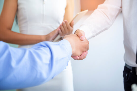 The image of two business people shaking hands after a successful business negotiation