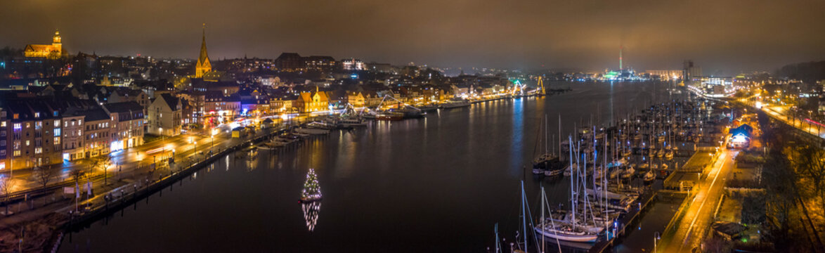 Panorama aerial view of of festive lighting and Christmas romantic atmosphere in the Flensburg at night. Nighttime view of Flensburg F&ouml;rde at Christmas time. Maritime Christmas city.