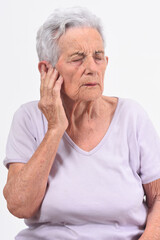 senior woman with pain on ear on white background