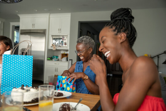 Family laughing during birthday celebration at home