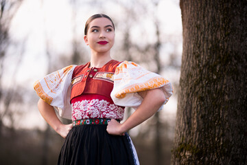 Young beautiful slovak woman in traditional dress. Slovak folklore