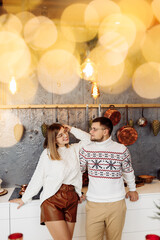 Lovely couple stand at the kitchen at home, look at each other, enjoy tender moments, cooking xmas dinner, prepare to Christmas celebration, cozy winter holidays concept