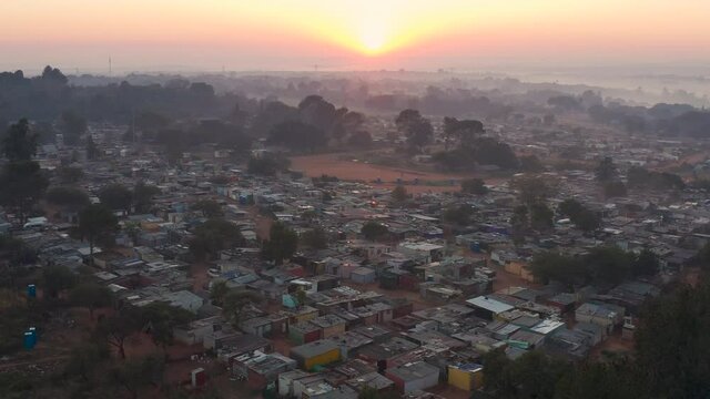 Sunrise zoom in aerial view of a squatter camp during lockdown for Covid-19 Coronavirus pandemic
