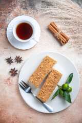 top view cake slices honey cake with cup of tea on light floor sweet pie biscuit cake