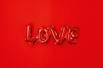 flat lay with love inscription on red background