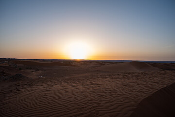 Fototapeta na wymiar Merzouga, Erg Chebbi, Morroco, Africa - April 30, 2019: Sun rises from the dunes